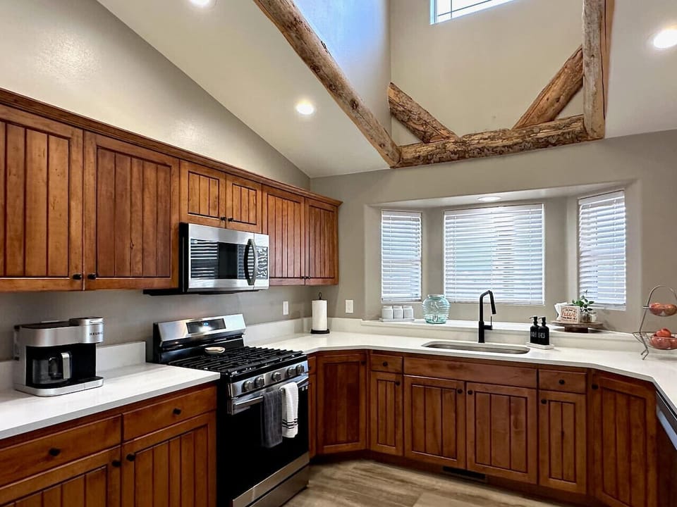 A fully equipped kitchen with stove top, coffee maker, and microwave awaits your culinary exploits, perfect for crafting meals with a view