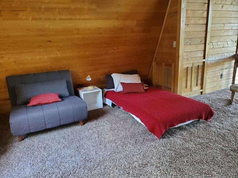 One of the two chairs in the loft folded out into a twin bed.