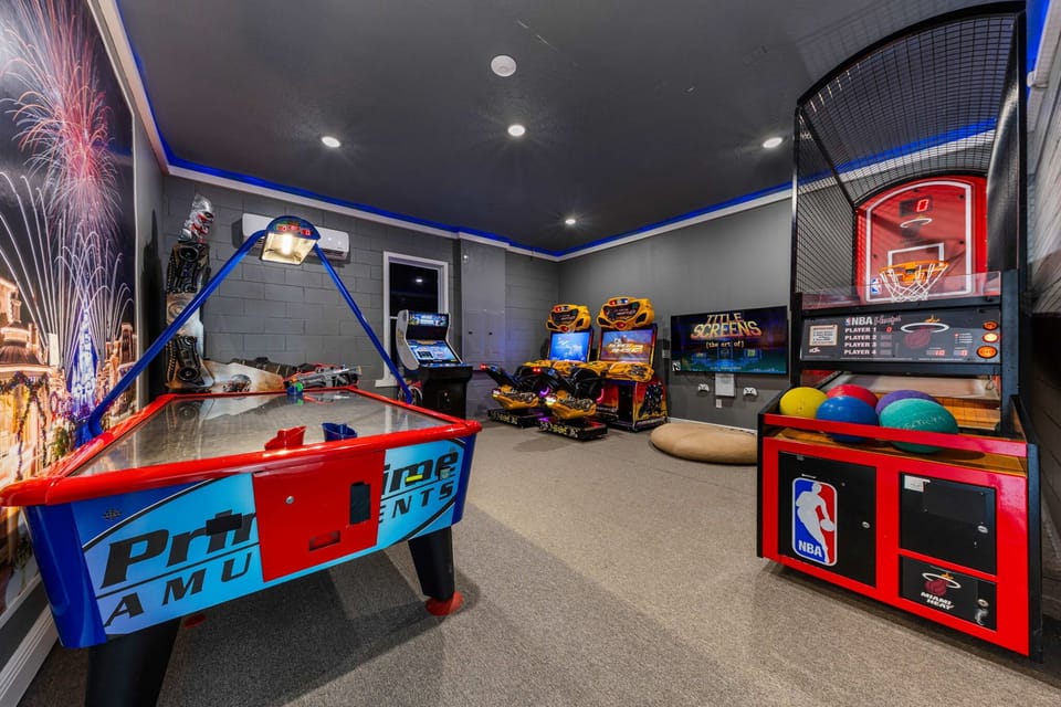 Multiple commercial arcade machines, air hockey, basketball, ride-on racing games, and more.