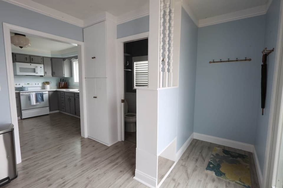 The kitchen extends into a large back entrance foyer with plenty of space to hang coats and towels, 