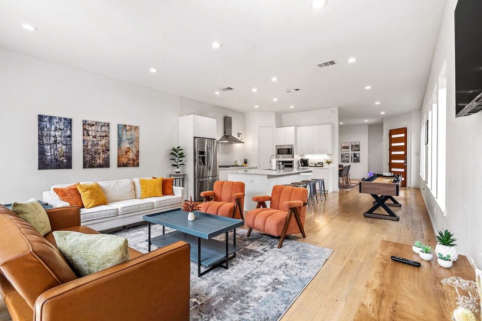 Spacious modern layout connecting the living room, kitchen, and game area perfect for entertaining friends or family.