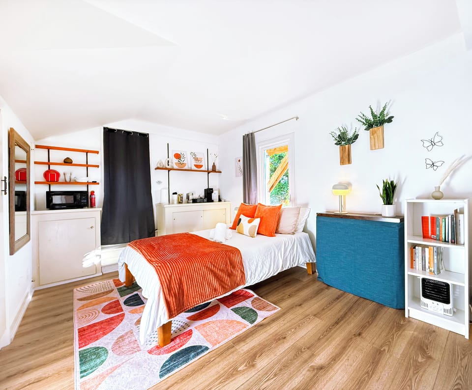 This cheerful studio features bold, uplifting décor, a cozy bed, and a handy coffee bar with a microwave—great for light snacks and morning brews.