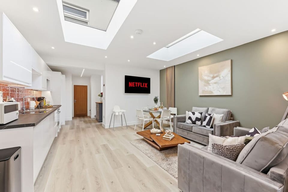 The open-plan kitchen and living area features skylights, creating a bright and airy space.