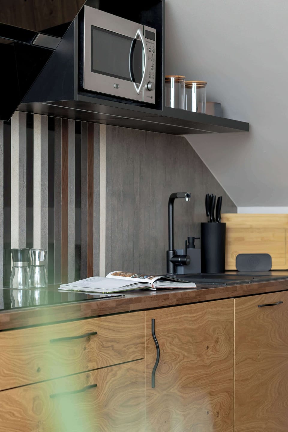 A final kitchen image showing the countertop, sink, and part of the cabinets. The setup emphasizes modern functionality and design.