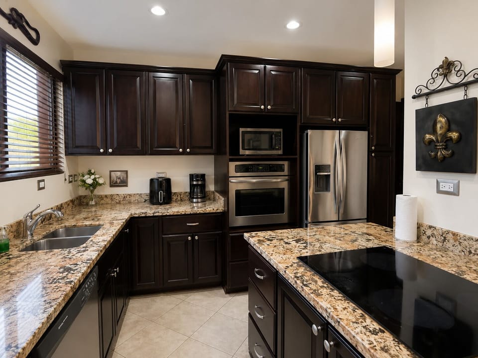 Fully equipped kitchen with granite counters and stainless appliances.