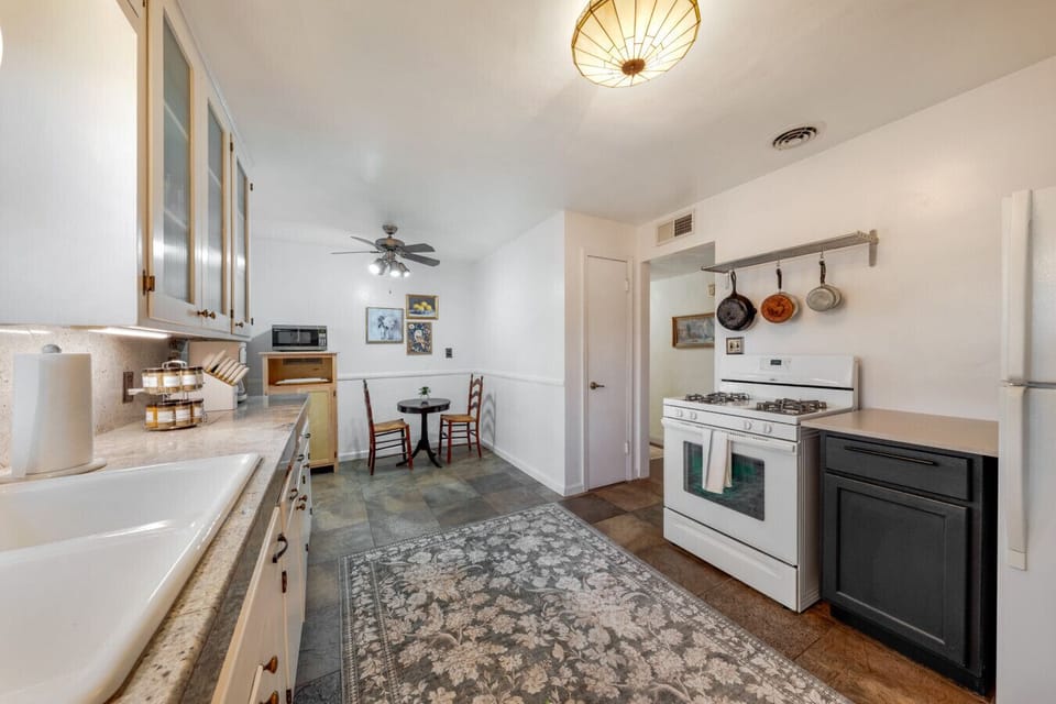 Fully equipped kitchen with plenty of counter space, dishwasher, gas stove, drip coffee maker, microwave, and a cozy breakfast nook just steps away