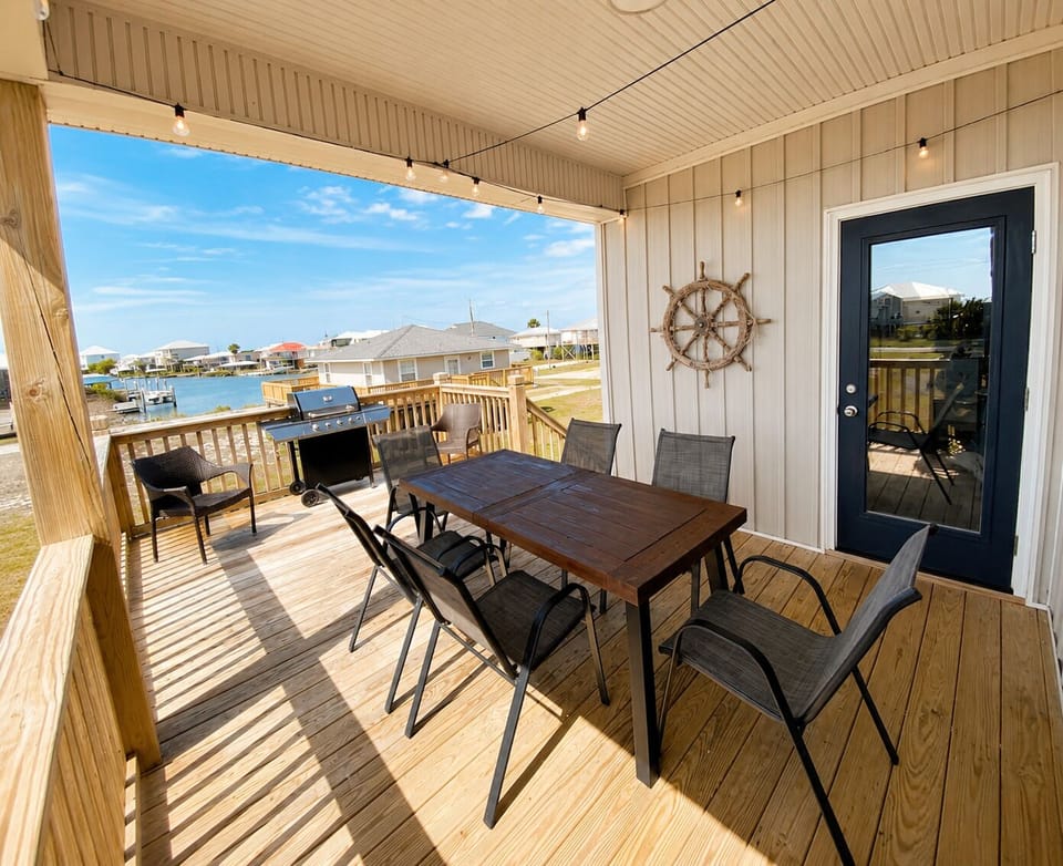 Back deck with view of canal and beautiful sunsets. New gas grill for your use. 