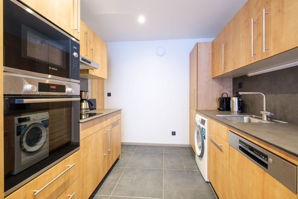 The fully equipped kitchen includes modern appliances and ample cabinetry, making it easy to prepare meals during your stay.