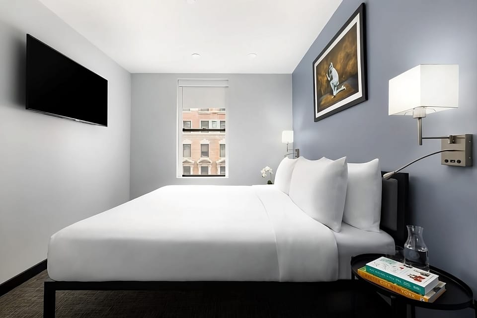 Sink into cloud-soft bedding and wake to gentle city light.