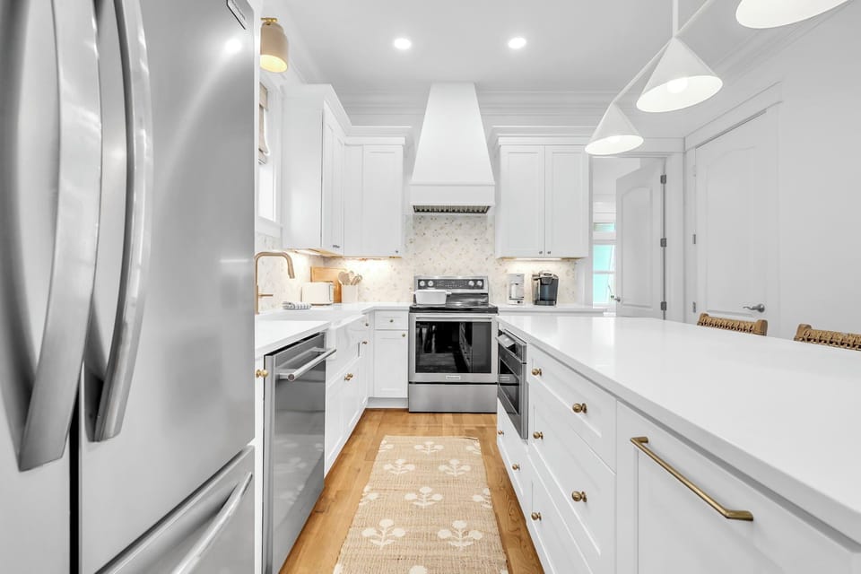 Fully stocked kitchen with a large island and seating for three