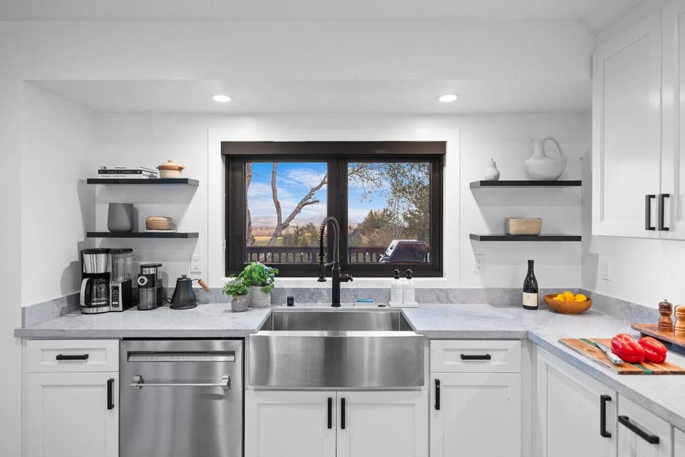 Enjoy picturesque views while preparing meals in this bright and modern kitchen, equipped with top-notch appliances and stylish decor.