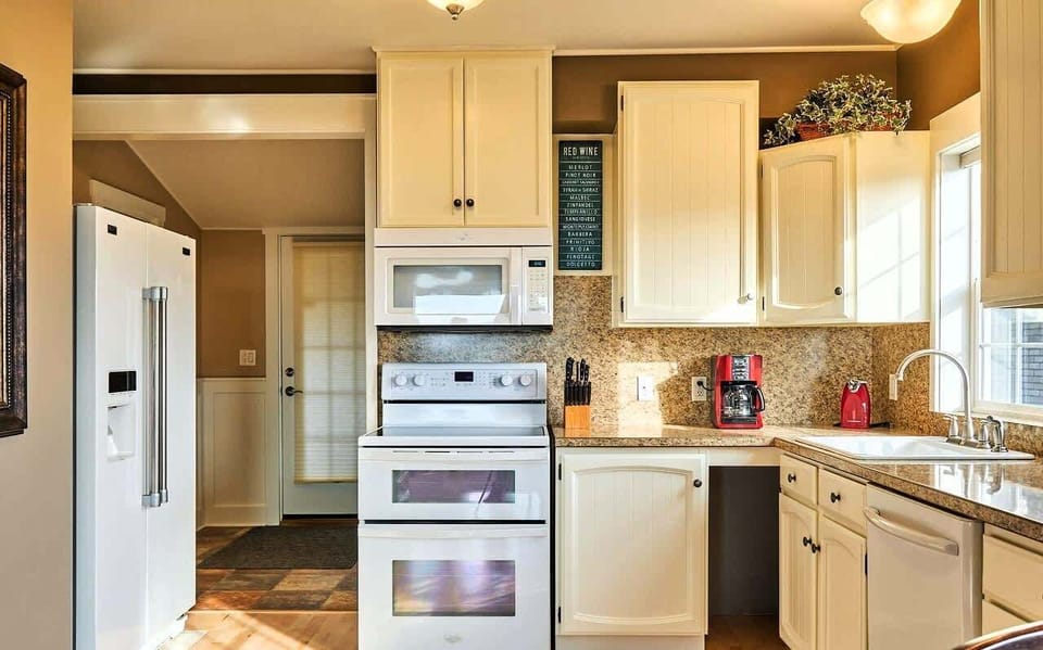 Fully equipped kitchen with granite counters, modern appliances, and plenty of space for cooking and gathering.