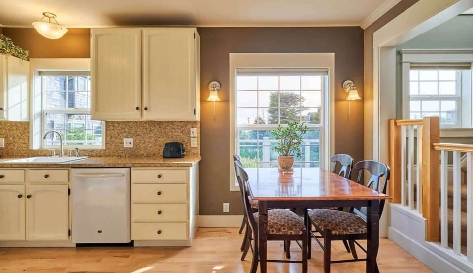 Inviting dining space next to the kitchen with a sunlit window and comfortable seating for shared meals.