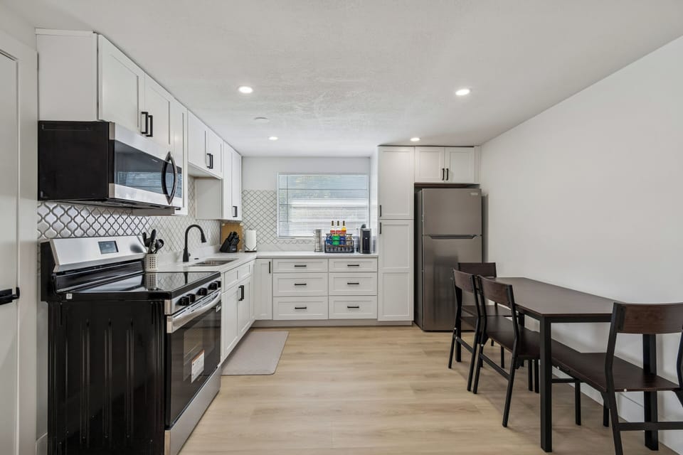 Kitchen with modern kitchen cabinets and amenities.