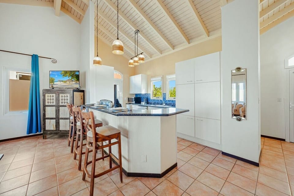 Fully equipped kitchen featuring modern appliances, cookware, essentials, and ample space for meal preparation.