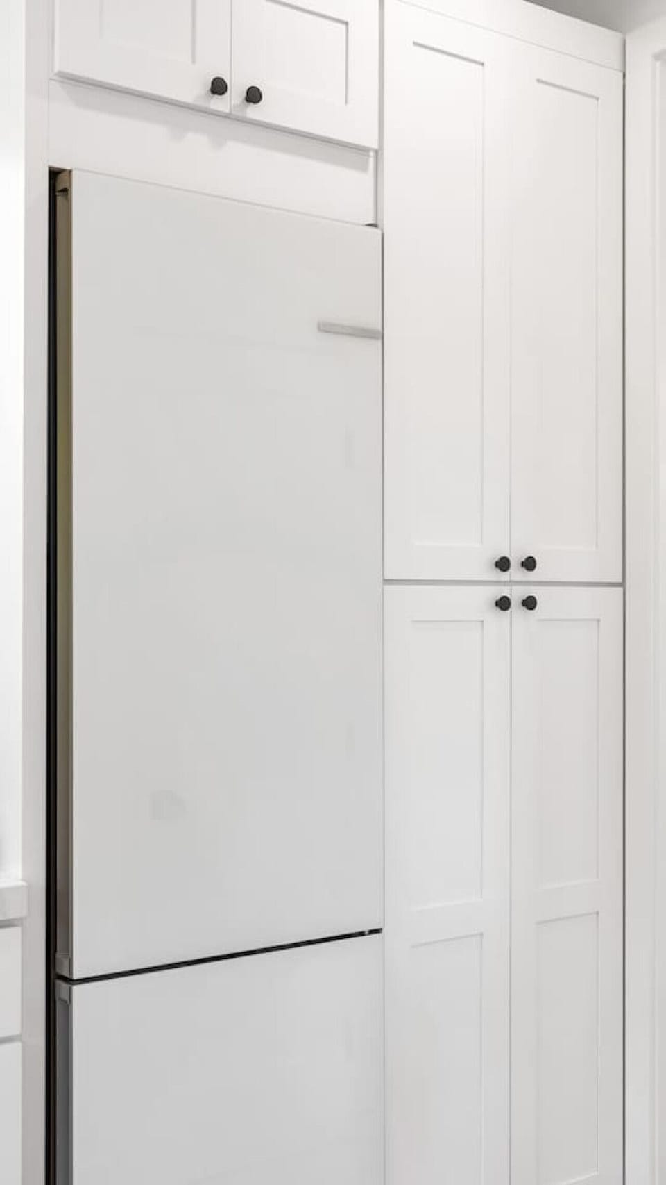 Spacious fridge neatly built into the cabinetry for a clean, uncluttered look.