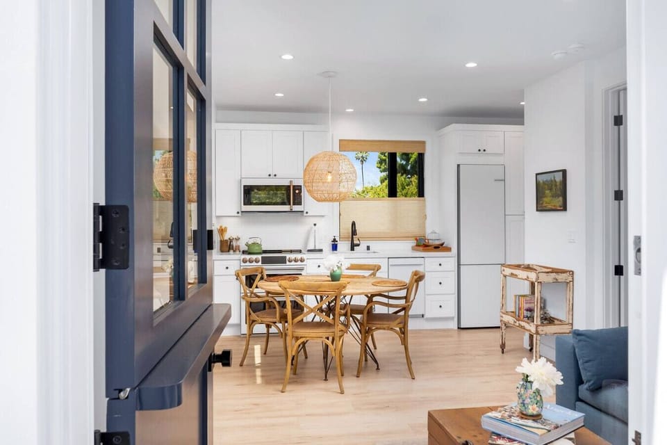 Bright, open kitchen and dining area with natural light and a warm, welcoming feel.