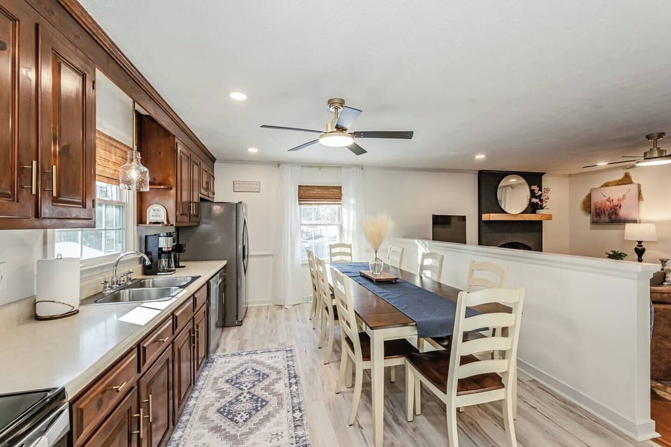 The well‑lit kitchen offers all the essentials, including a microwave, fridge, oven, Keurig and drip coffee, and plenty of cabinet storage. A double‑basin sink sits beneath a sunny window, and the adjacent laundry nook keeps everything convenient.