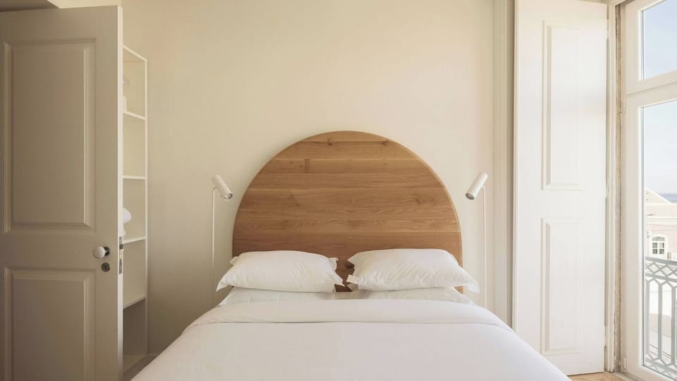 Wake up refreshed beside tall balcony doors and sea breeze.