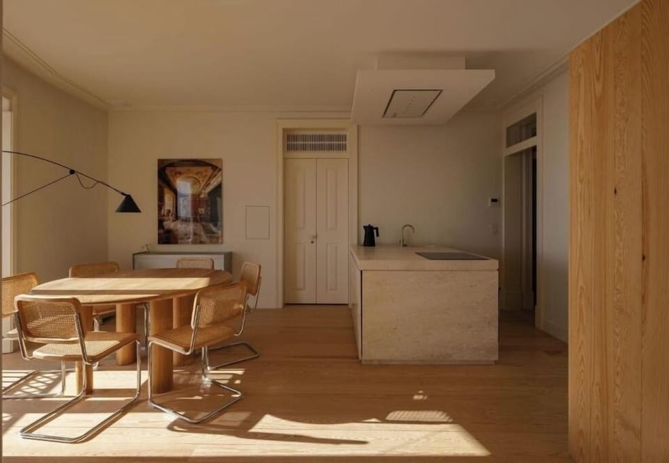 Gather for sunny meals beside the sleek kitchen island.