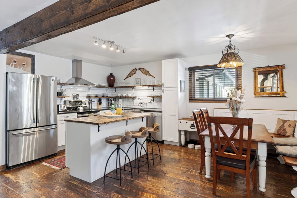 Rustic-chic kitchen and dining area with a breakfast bar—made for easy mornings and cozy meals after a day on the mountain.