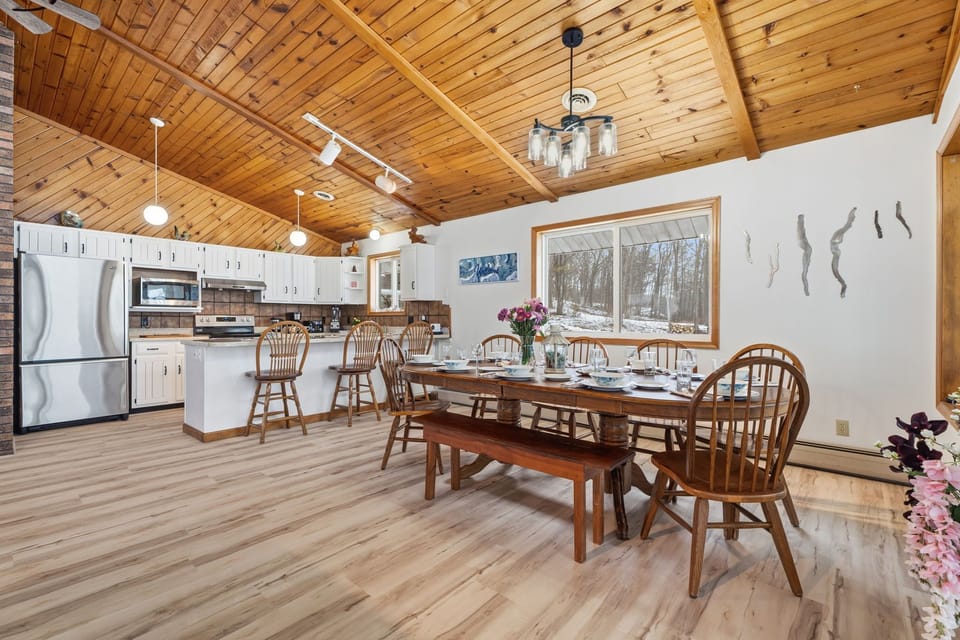 Open dining area with seating for the whole group, set beneath vaulted wood ceilings and just steps from the kitchen.