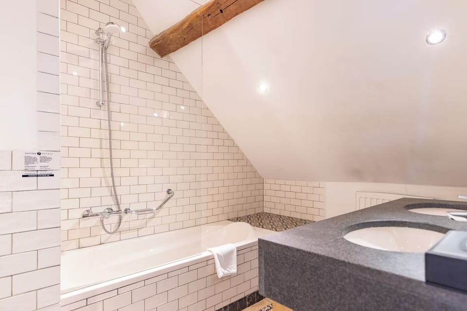 Indulge in a long soak beneath warm lights and tiled serenity