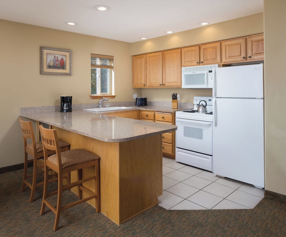 Two-Bedroom-Kitchen-Whispering-Woods-Resorts
