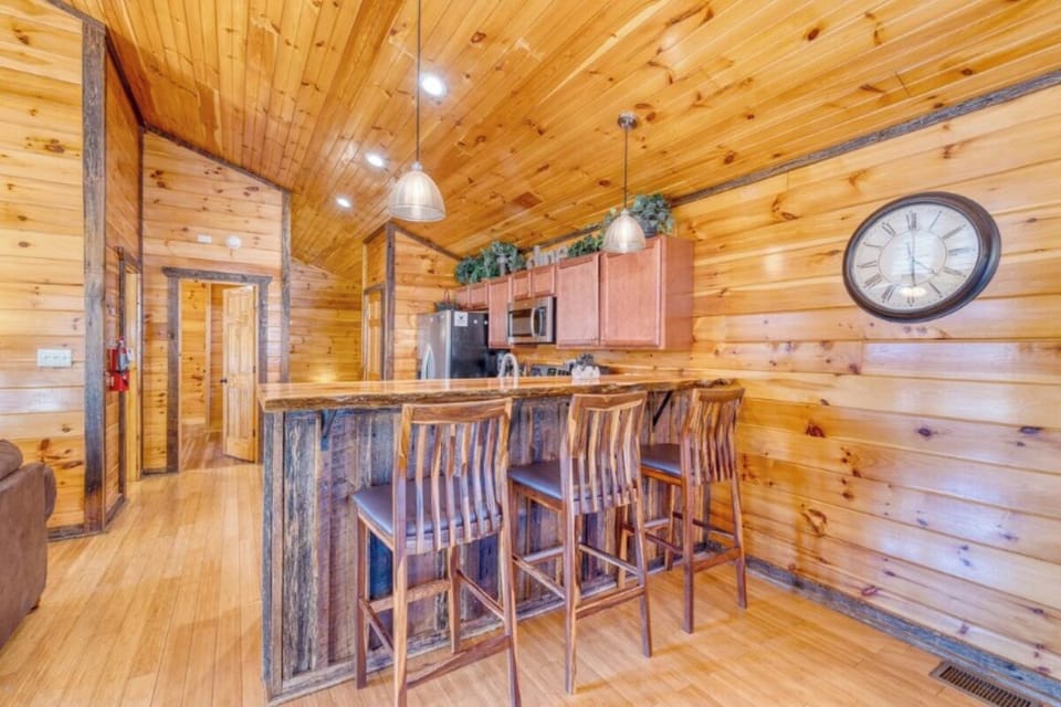 Gather around this stunning log cabin kitchen where rustic charm meets modern convenience for your mountain getaway meals.