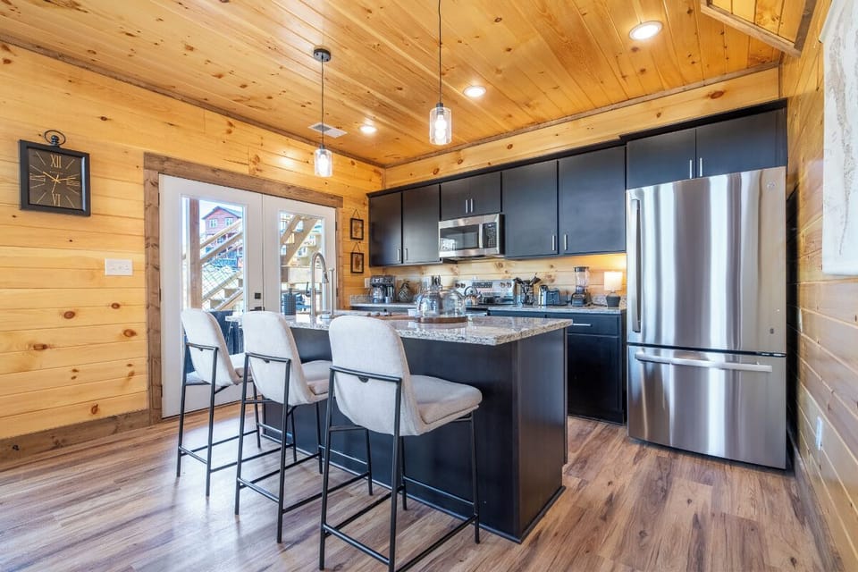 Your fully-equipped kitchen awaits with sleek appliances and a breakfast bar for your morning coffee ritual.