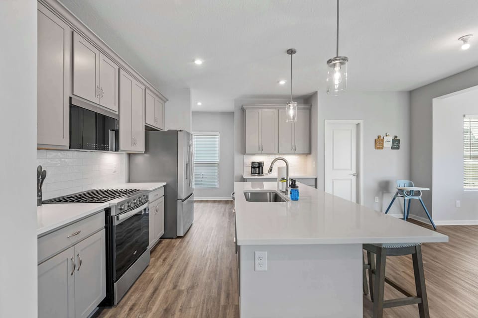 The chic, open kitchen offers ample space & all the comforts of home​