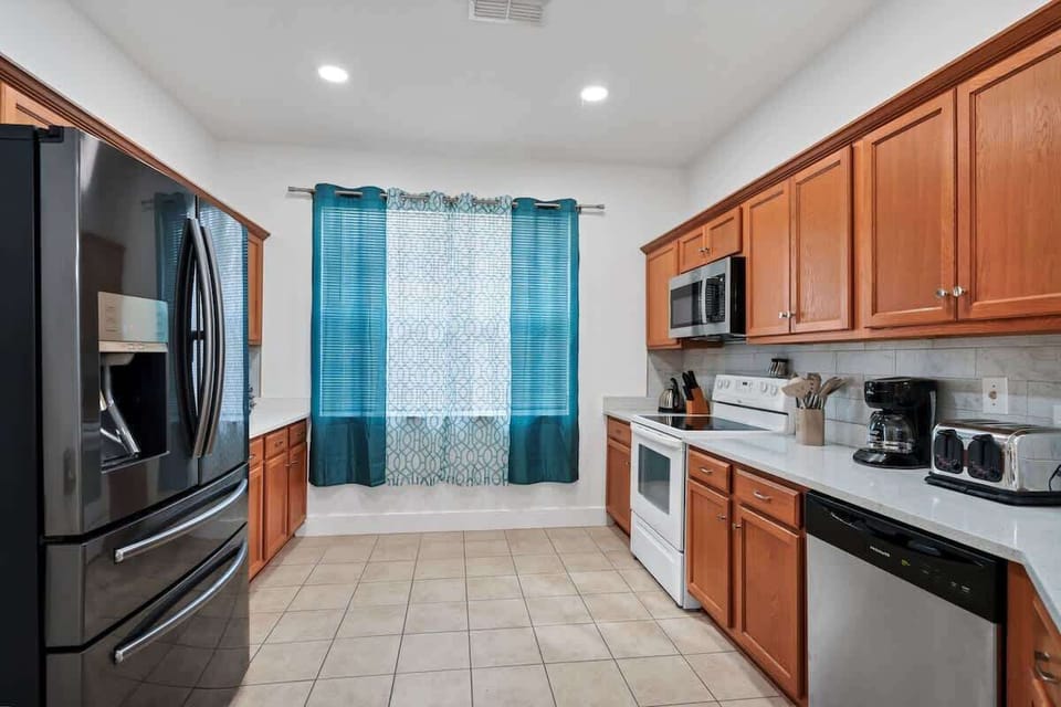 Fully stocked kitchen with modern appliances for home cooking