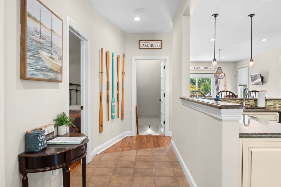A warm lake house welcome with cozy decor and an open flow to the kitchen