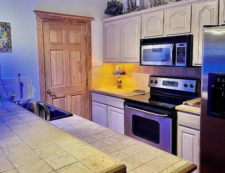 Fully equipped kitchen with convenient laundry access