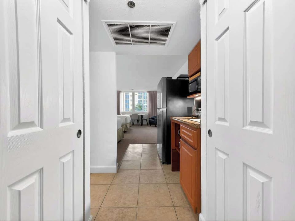 Compact kitchen equipped with essentials and a dining table for 4.