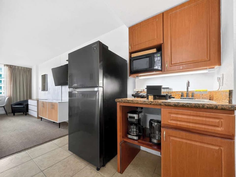 Compact kitchen equipped with essentials and a dining table for 4.