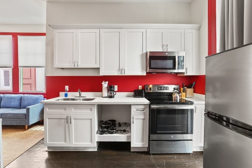 Bright, fully equipped kitchen with modern appliances, generous counter space, and essential cookware. Clean, functional layout designed for easy meal prep during short or extended stays.