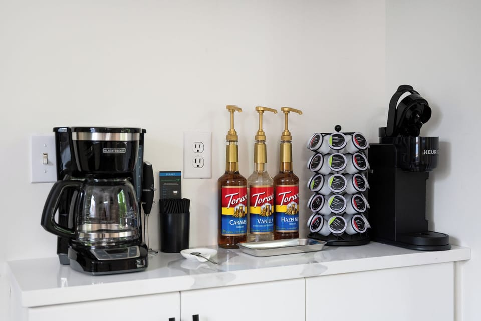 Fully-stocked and ready to enjoy Coffee Bar on main level next to the kitchen