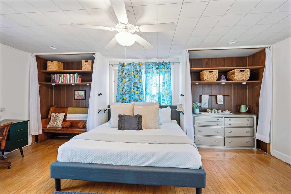 The primary bedroom boasts a plush king-sized bed & a smart TV​