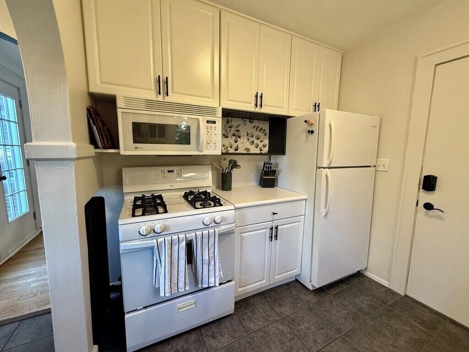 Full size appliances, 8+ pots and pans set, dishes for 6+ people, spices, cookbooks, and plenty of utensils are all provided.