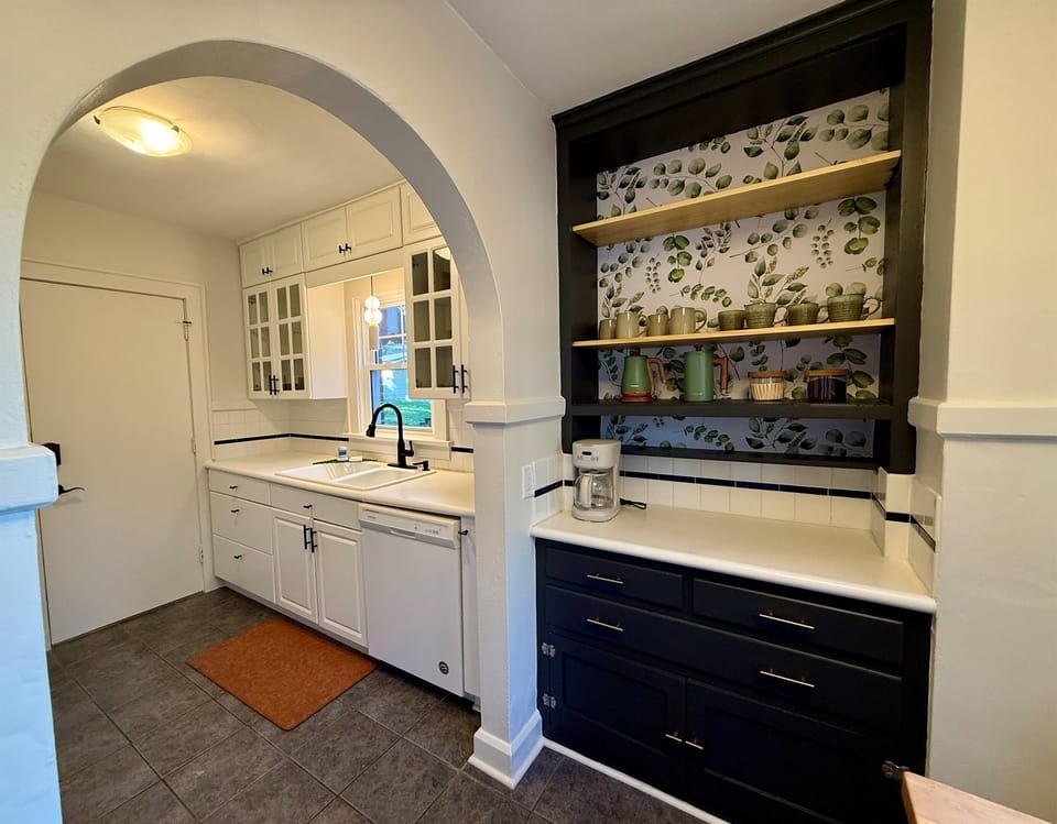 Archways from the Breakfast Nook to the fully stocked kitchen.