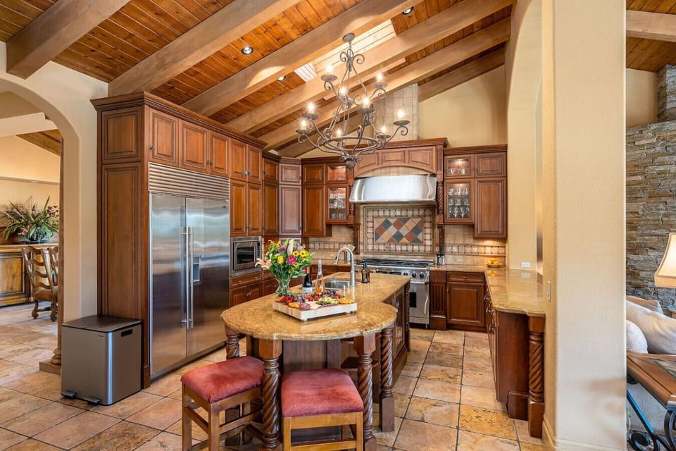 Kitchen: fully stocked kitchen with stainless steel appliances (double range, built in french door refrigerator, built in oven and microwave, dishwasher), 2 bar stools