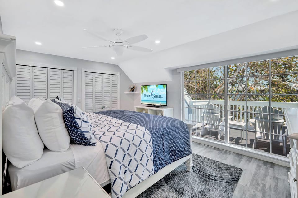 Primary bedroom with slider access to private balcony