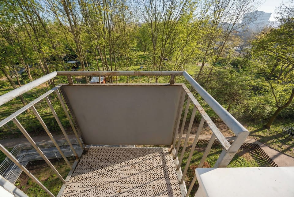 Balcony overlooking the green surroundings. 