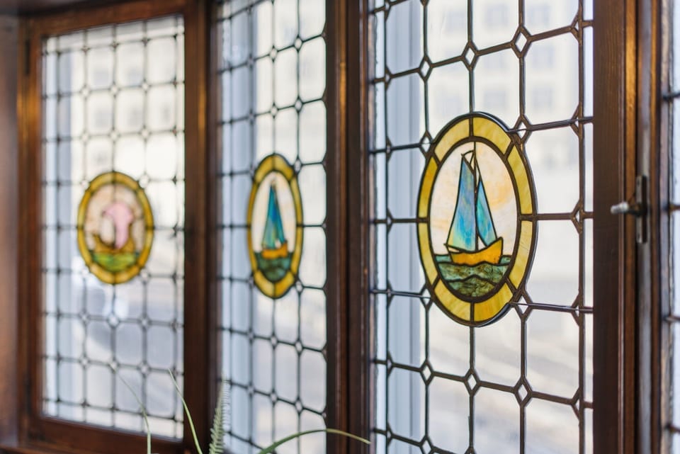 Admire the charming stained glass windows that fill your space with colorful light and nautical charm throughout the day.
