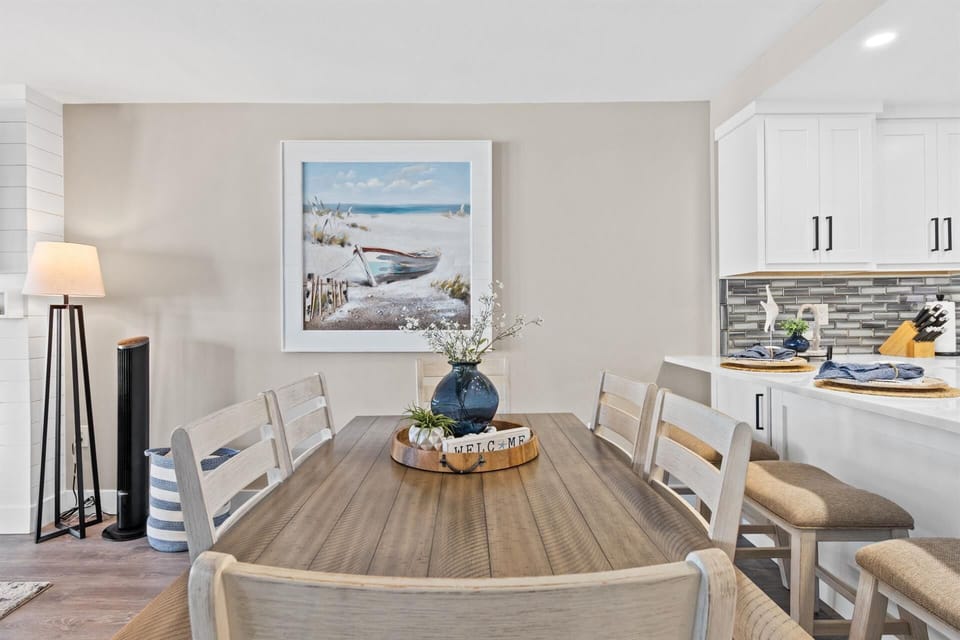 Gather around this coastal-inspired dining table for memorable meals with loved ones in your serene beachside retreat.