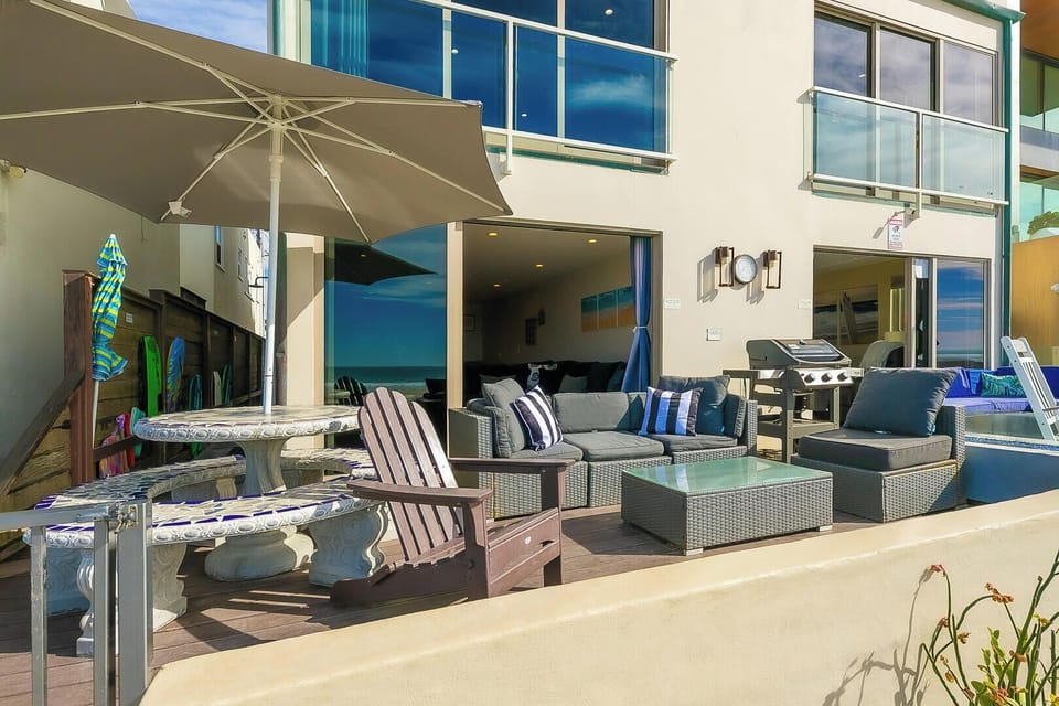 Outdoor area featuring a dining set, lounge seating, and a BBQ grill perfect for entertaining, relaxing, and enjoying meals al fresco.