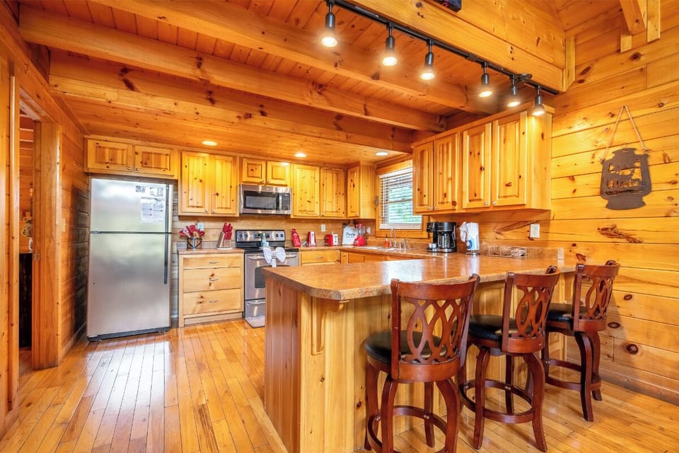 Cook your favorite meals in this warm, rustic kitchen featuring rich wood finishes and modern amenities.