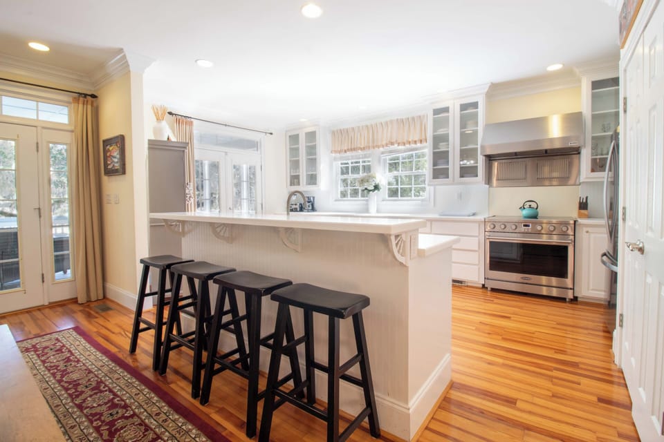 Your bright, spacious kitchen awaits with gleaming counters, modern appliances, and a welcoming breakfast bar perfect for morning coffee.