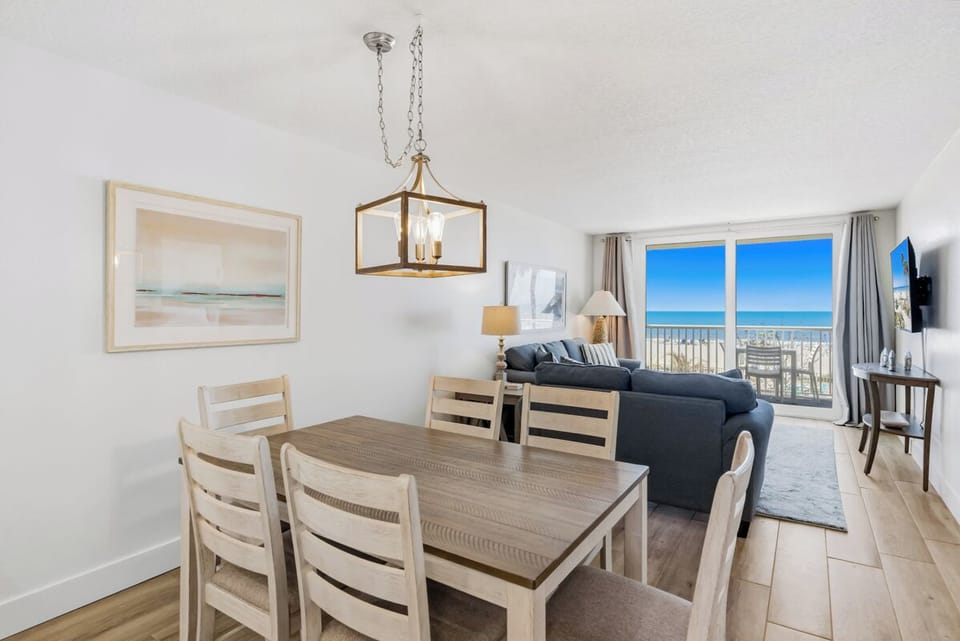 Gather around your dining table while soaking in stunning ocean views through floor-to-ceiling windows that frame the endless blue horizon.